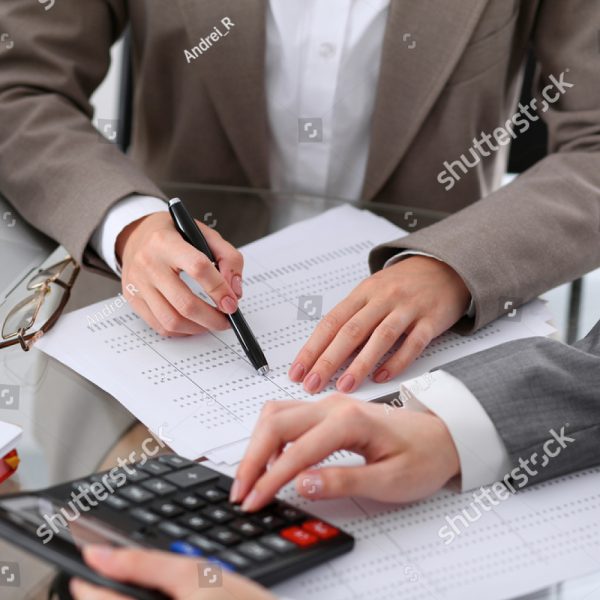 stock-photo-two-female-accountants-counting-on-calculator-income-for-tax-form-completion-hands-closeup-519746476